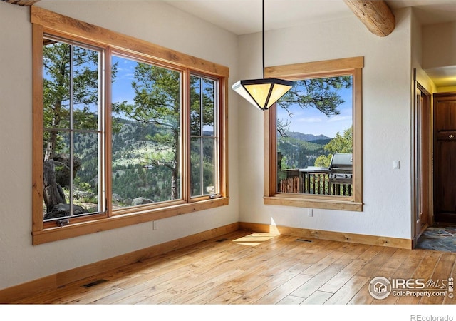 409 Wild Horse Cir, Boulder, CO 80304 - unfurnished dining area with light wood-style floors and healthy amount of natural light