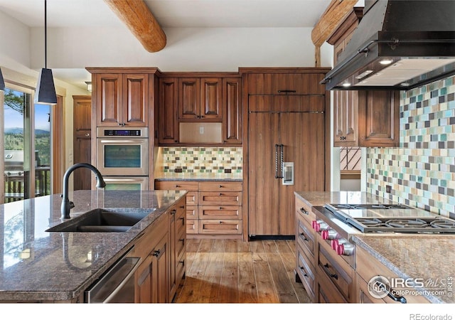 409 Wild Horse Cir, Boulder, CO 80304 - kitchen featuring exhaust hood, appliances with stainless steel finishes, beamed ceiling, tasteful backsplash, and light wood-style floors