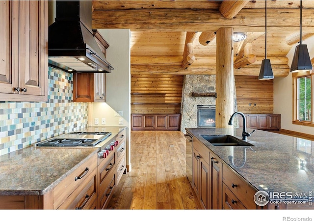 409 Wild Horse Cir, Boulder, CO 80304 - kitchen featuring extractor fan, log walls, light wood-style floors, stainless steel gas cooktop, and open floor plan