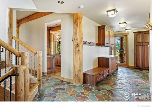 409 Wild Horse Cir, Boulder, CO 80304 - kitchen featuring stone floors, brown cabinetry, and recessed lighting