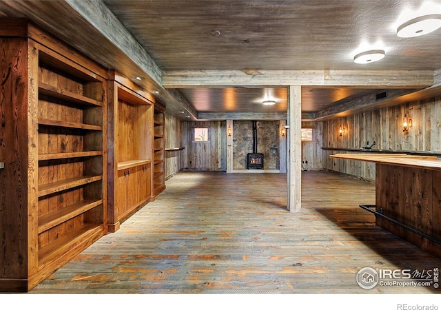 409 Wild Horse Cir, Boulder, CO 80304 - finished below grade area with a wood stove, wood-type flooring, and wooden walls