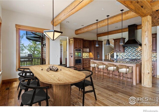 409 Wild Horse Cir, Boulder, CO 80304 - dining space with light wood finished floors, beamed ceiling, and recessed lighting