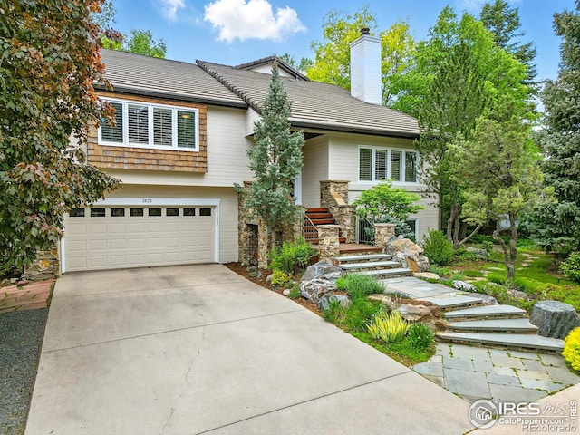 3835 Norwood Ct, Boulder, CO 80304 - view of front of house with a garage, driveway, and a chimney
