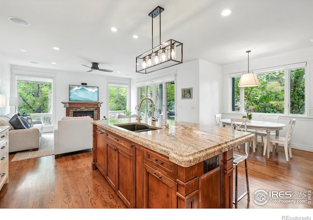 3835 Norwood Ct, Boulder, CO 80304 - kitchen featuring a sink, plenty of natural light, a stone fireplace, open floor plan, and recessed lighting