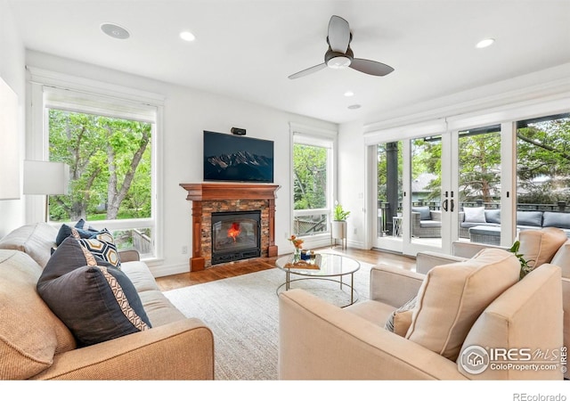 3835 Norwood Ct, Boulder, CO 80304 - living room featuring healthy amount of natural light, a glass covered fireplace, recessed lighting, and wood finished floors
