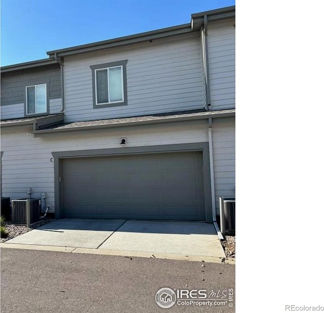 539 Vicot Way Unit C, Fort Collins, CO 80524 - garage featuring cooling unit and driveway