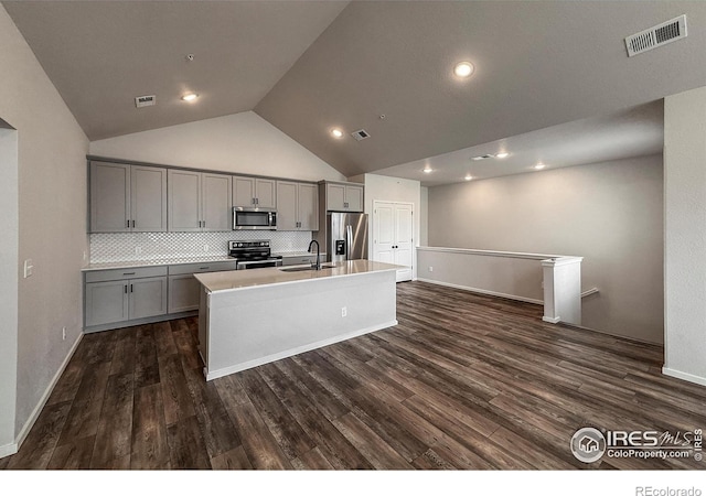 539 Vicot Way Unit C, Fort Collins, CO 80524 - kitchen with stainless steel appliances, gray cabinetry, an island with sink, dark wood-style floors, and high vaulted ceiling