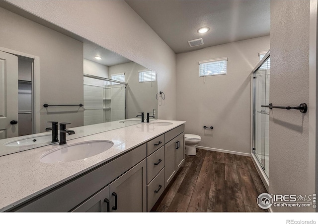 539 Vicot Way Unit C, Fort Collins, CO 80524 - bathroom with a stall shower, double vanity, wood finished floors, and recessed lighting