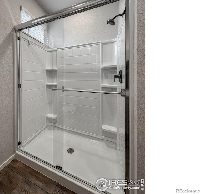 539 Vicot Way Unit C, Fort Collins, CO 80524 - bathroom featuring a textured wall, wood finished floors, and a shower stall