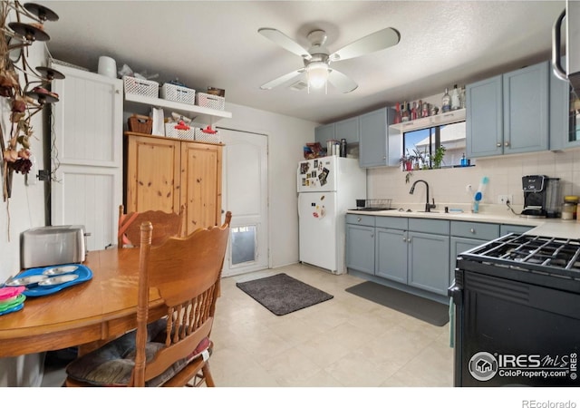 6743 King St, Denver, CO 80221 - kitchen featuring freestanding refrigerator, a sink, light countertops, ceiling fan, and tasteful backsplash