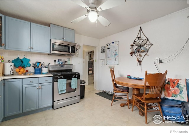 6743 King St, Denver, CO 80221 - kitchen with appliances with stainless steel finishes, blue cabinetry, a ceiling fan, and light countertops