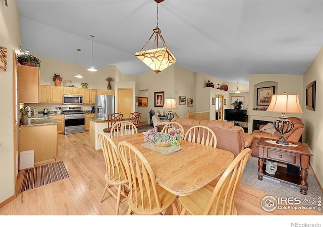 13112 Summit Grove Pkwy, Thornton, CO 80241 - dining space featuring light wood finished floors and high vaulted ceiling