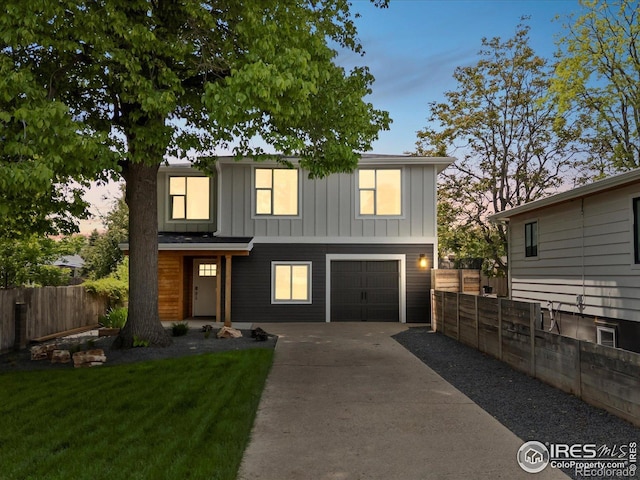 404 W Cleveland St, Lafayette, CO 80026 - view of front of home featuring driveway, board and batten siding, and an attached garage