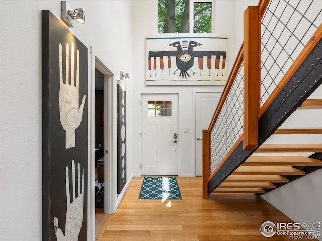 404 W Cleveland St, Lafayette, CO 80026 - entryway featuring stairs, wood finished floors, a high ceiling, and baseboards