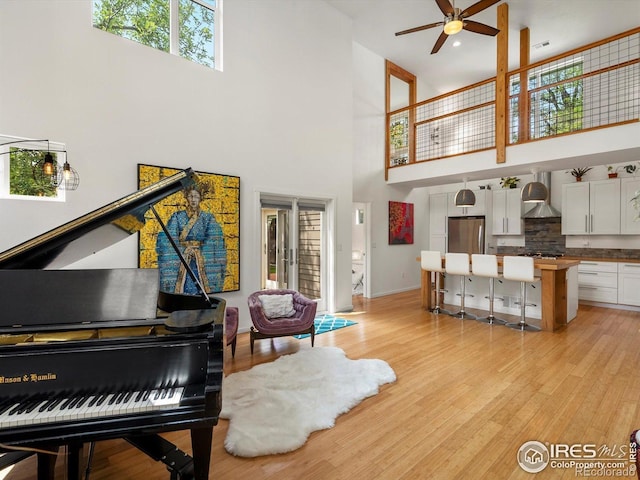 404 W Cleveland St, Lafayette, CO 80026 - living area with a high ceiling, ceiling fan, light wood finished floors, and baseboards