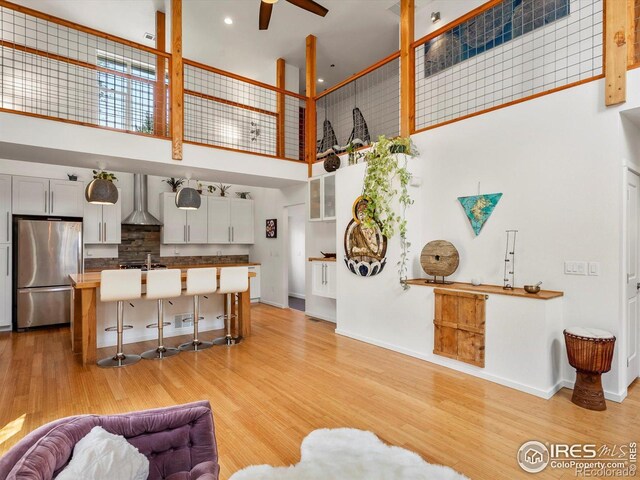404 W Cleveland St, Lafayette, CO 80026 - living room with a high ceiling, ceiling fan, light wood finished floors, baseboards, and recessed lighting