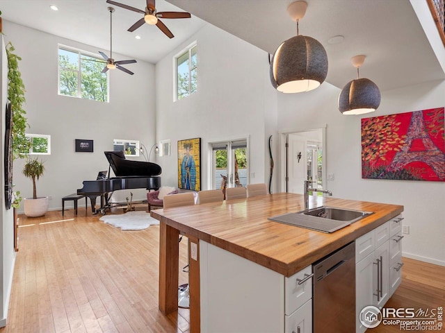 404 W Cleveland St, Lafayette, CO 80026 - kitchen with butcher block counters, dishwasher, open floor plan, ceiling fan, and white cabinets