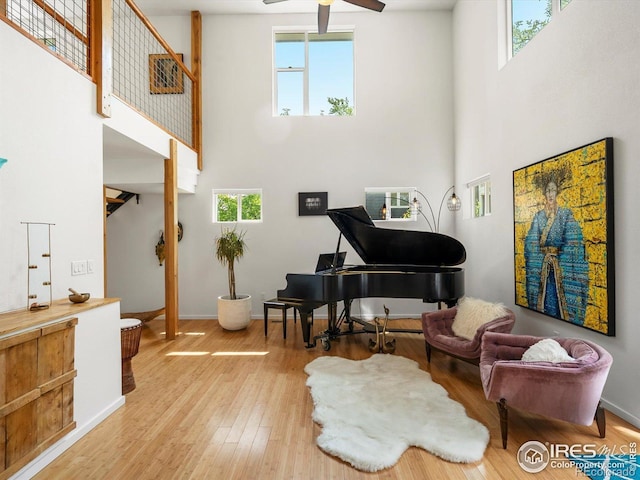 404 W Cleveland St, Lafayette, CO 80026 - sitting room featuring a high ceiling, ceiling fan, wood finished floors, and baseboards