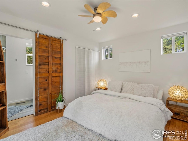 404 W Cleveland St, Lafayette, CO 80026 - bedroom featuring a barn door, wood finished floors, and recessed lighting
