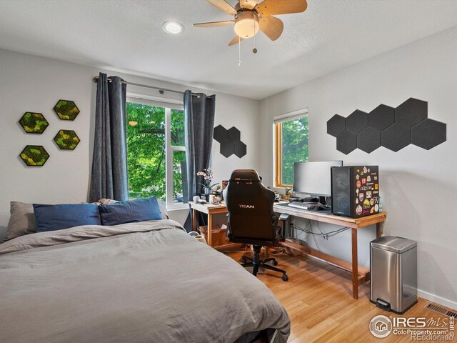 404 W Cleveland St, Lafayette, CO 80026 - bedroom featuring multiple windows, wood finished floors, baseboards, and a desk