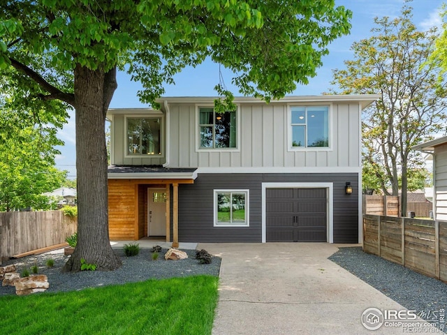 404 W Cleveland St, Lafayette, CO 80026 - view of front of house featuring driveway, an attached garage, and board and batten siding