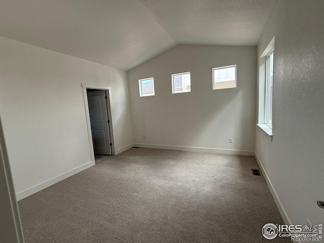 6113 Zebulon Pl, Timnath, CO 80547 - spare room with vaulted ceiling, carpet, and baseboards