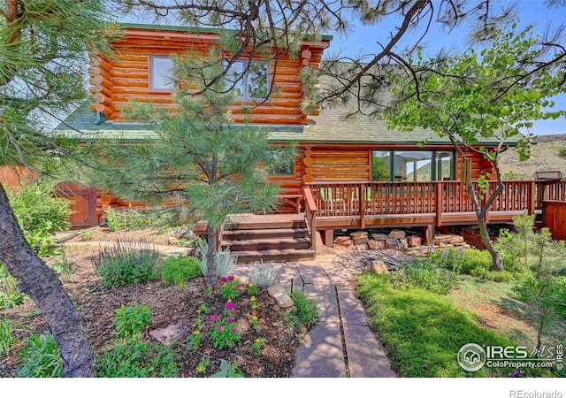 114 Jade Way, Lyons, CO 80540 - back of property with log exterior and a wooden deck