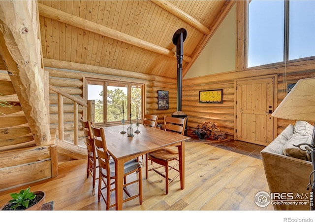 114 Jade Way, Lyons, CO 80540 - dining area featuring rustic walls, wooden ceiling with exposed beams, wood-type flooring, and high vaulted ceiling