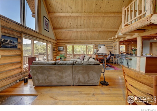 114 Jade Way, Lyons, CO 80540 - living room with rustic walls, high vaulted ceiling, wooden ceiling with exposed beams, and hardwood / wood-style flooring