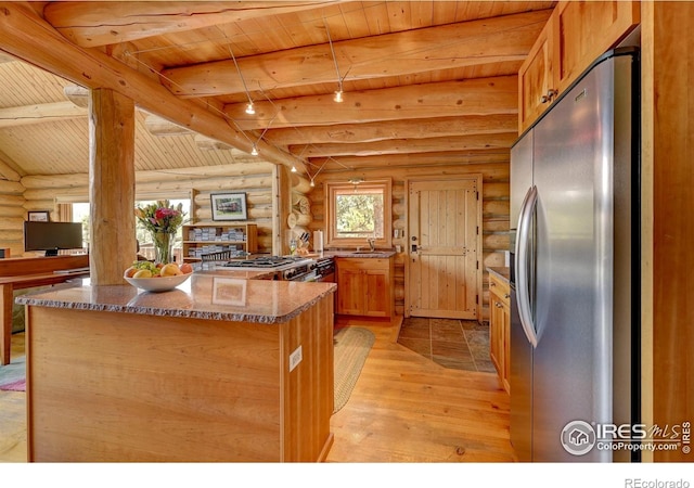 114 Jade Way, Lyons, CO 80540 - kitchen with freestanding refrigerator, log walls, wooden ceiling with exposed beams, light wood-style flooring, and dark stone countertops