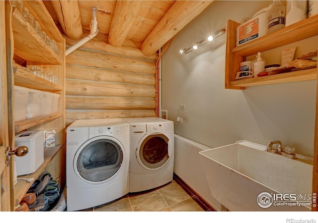 114 Jade Way, Lyons, CO 80540 - washroom with rustic walls, washer and dryer, a wainscoted wall, and light tile patterned floors