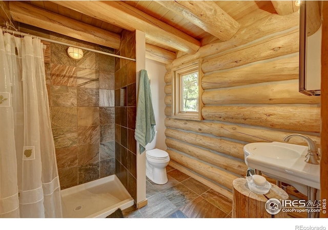 114 Jade Way, Lyons, CO 80540 - bathroom with toilet, a stall shower, wooden ceiling with exposed beams, and log walls