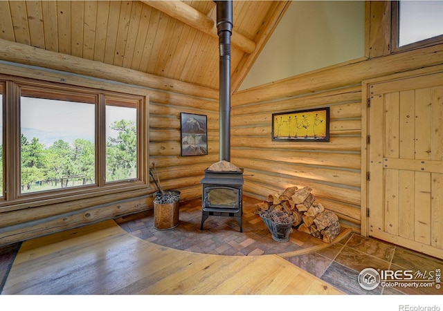 114 Jade Way, Lyons, CO 80540 - detailed view of a wood stove, wood ceiling with exposed beams, and log walls