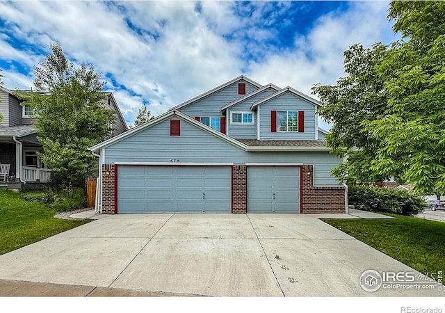 678 Mcclure Ct, Erie, CO 80516 - view of front of home featuring brick siding, driveway, a garage, and a front lawn