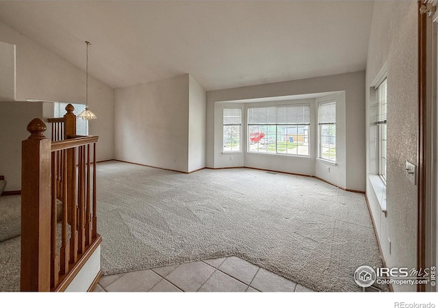 678 Mcclure Ct, Erie, CO 80516 - unfurnished room featuring carpet flooring, vaulted ceiling, a chandelier, and baseboards