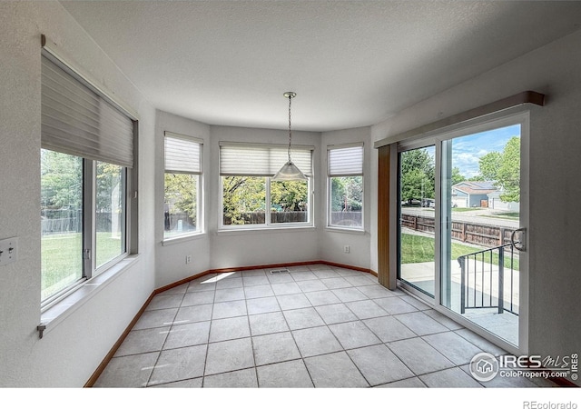 678 Mcclure Ct, Erie, CO 80516 - unfurnished sunroom featuring tile patterned flooring and baseboards