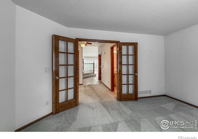 678 Mcclure Ct, Erie, CO 80516 - spare room with french doors, carpet, a textured ceiling, and baseboards
