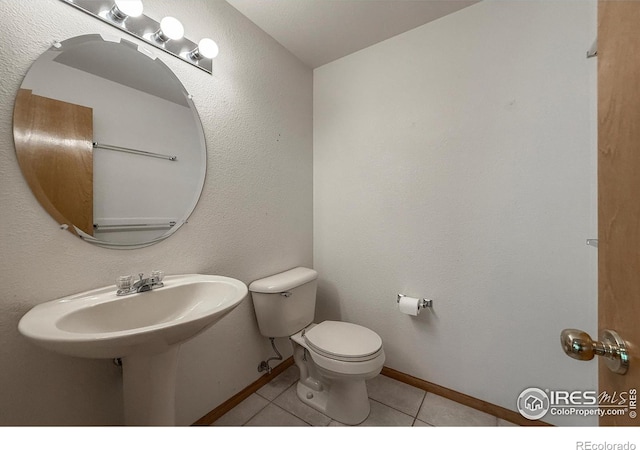 678 Mcclure Ct, Erie, CO 80516 - half bathroom featuring tile patterned flooring, toilet, and baseboards