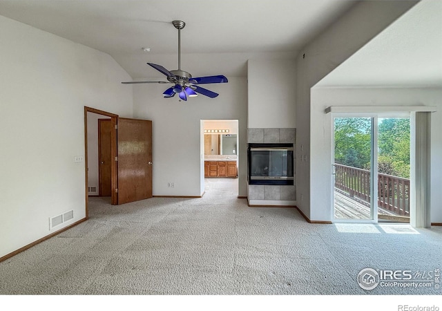678 Mcclure Ct, Erie, CO 80516 - unfurnished living room featuring carpet floors, a tiled fireplace, baseboards, ceiling fan, and high vaulted ceiling