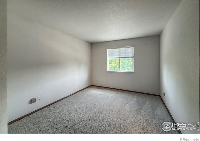 678 Mcclure Ct, Erie, CO 80516 - carpeted spare room featuring baseboards and a textured ceiling