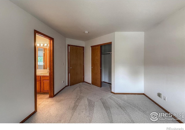 678 Mcclure Ct, Erie, CO 80516 - unfurnished bedroom with light carpet, baseboards, ensuite bathroom, a closet, and a sink