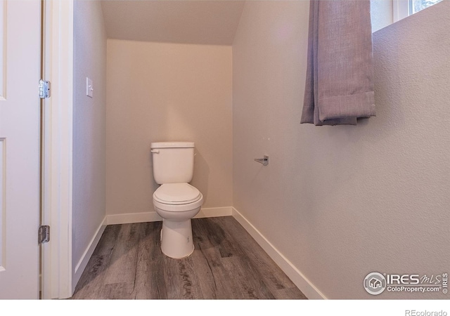 710 Oregon Trl Unit B1, Ault, CO 80610 - bathroom with wood finished floors, toilet, and baseboards