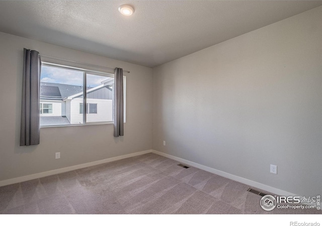 710 Oregon Trl Unit B1, Ault, CO 80610 - carpeted spare room featuring baseboards and a textured ceiling