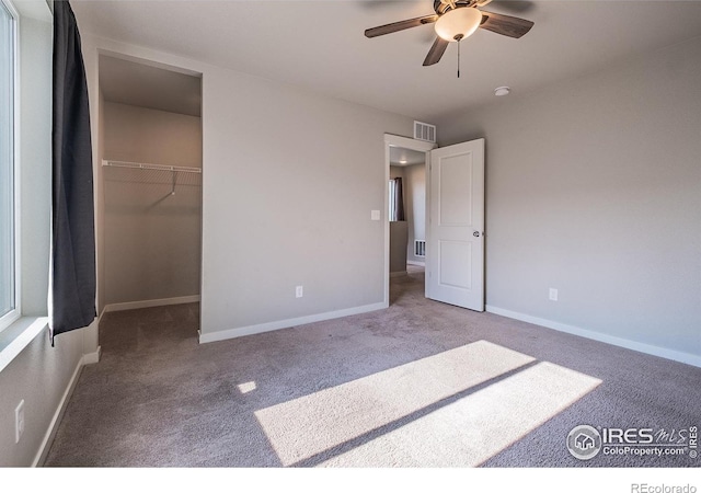 710 Oregon Trl Unit B1, Ault, CO 80610 - unfurnished bedroom with carpet, a spacious closet, baseboards, and ceiling fan