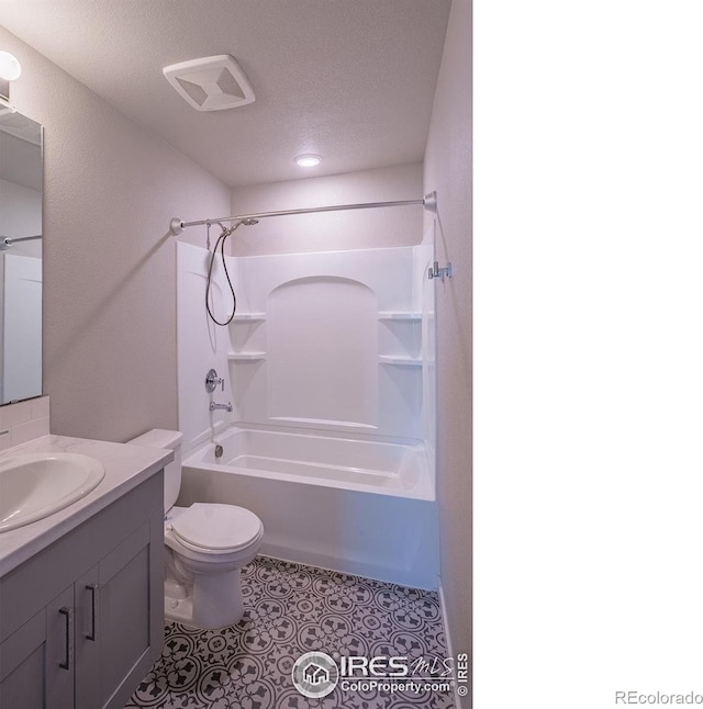 710 Oregon Trl Unit B1, Ault, CO 80610 - bathroom with vanity, bathtub / shower combination, toilet, a textured ceiling, and tile patterned floors
