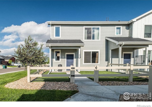 710 Oregon Trl Unit B1, Ault, CO 80610 - multi unit property with a fenced front yard, covered porch, and a gate