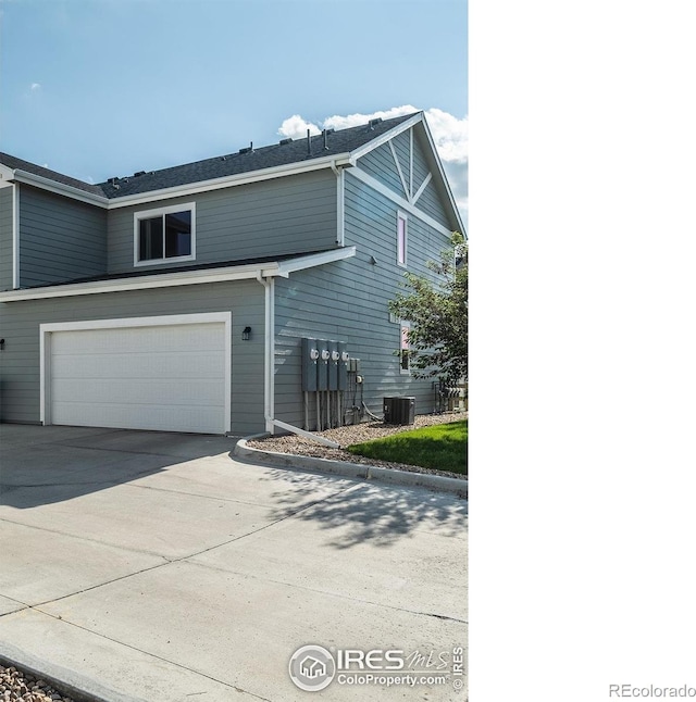 710 Oregon Trl Unit B1, Ault, CO 80610 - view of property exterior with a garage, driveway, and central air condition unit