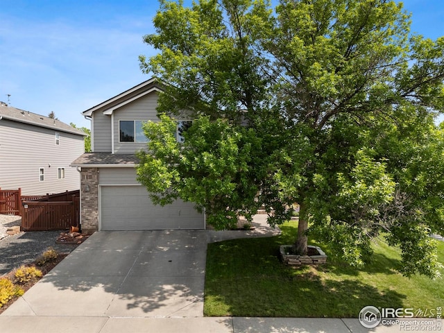 1502 Westfield Dr, Fort Collins, CO 80526 - view of property hidden behind natural elements featuring driveway, an attached garage, and brick siding