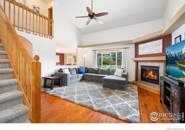 1502 Westfield Dr, Fort Collins, CO 80526 - living area featuring wood finished floors, stairway, a fireplace, ceiling fan, and high vaulted ceiling