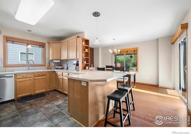 1502 Westfield Dr, Fort Collins, CO 80526 - kitchen featuring stainless steel dishwasher, a peninsula, a sink, open shelves, and a breakfast bar